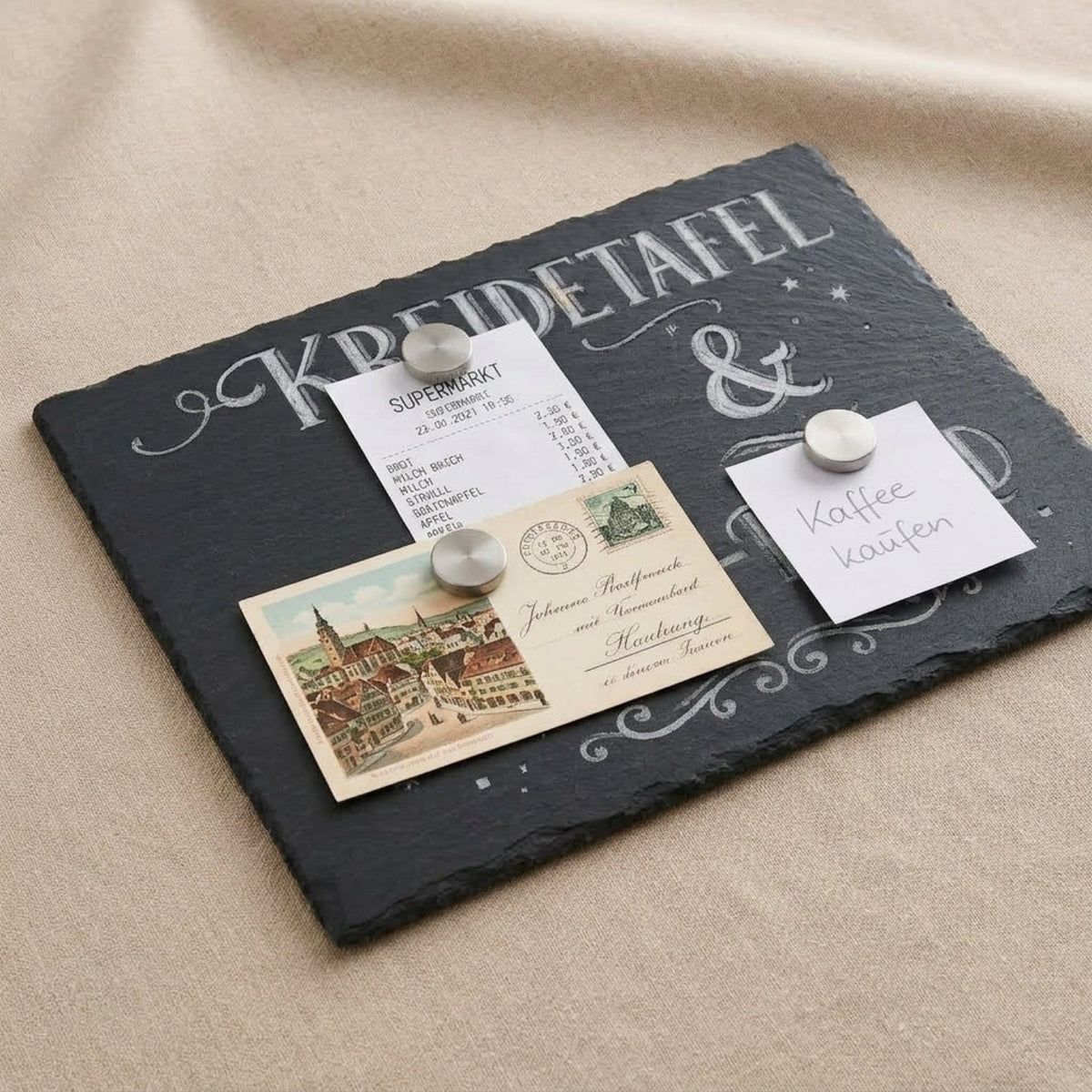 Close-up of the magnetic chalk board holding a receipt and postcard with magnets — Skillberry